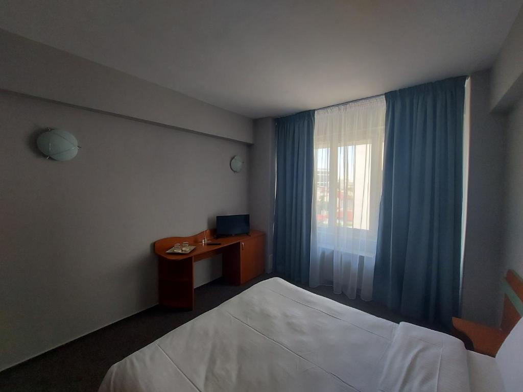 Postel nebo postele na pokoji v ubytování Elizeu Hotel