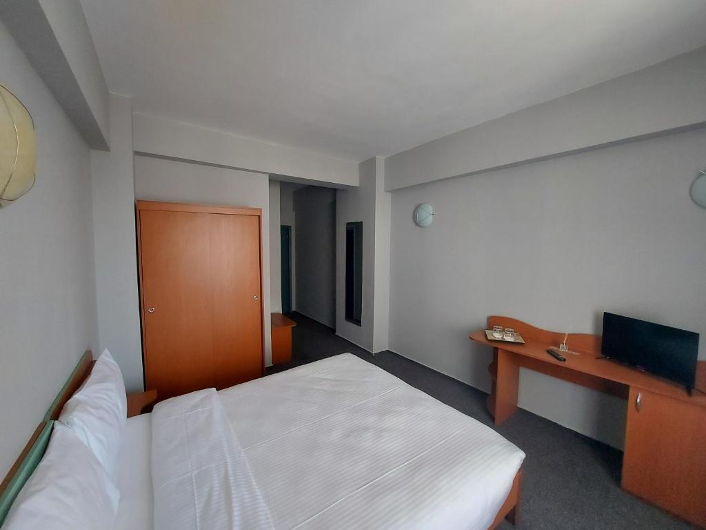 Postel nebo postele na pokoji v ubytování Elizeu Hotel