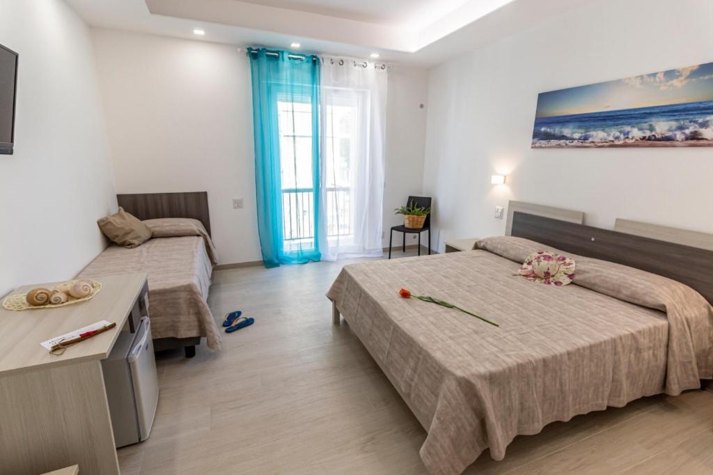 A bed or beds in a room at Incanto di luna B&b Family Rooms