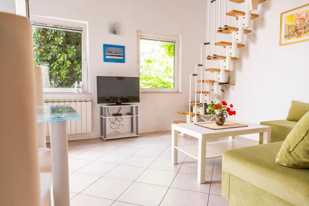 a living room with a couch and a table at Oleander in Portorož