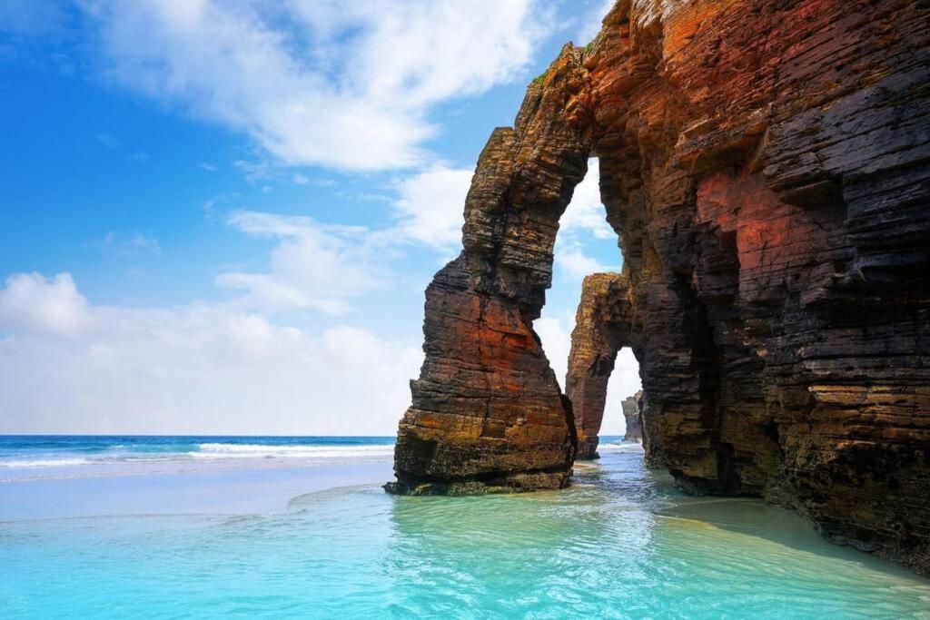 an arch in the rocks on the beach at APARTAMENTO PLAYA CATEDRALES CON TERRAZA in Barreiros