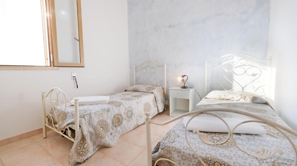 Postel nebo postele na pokoji v ubytování Apartment Mikao - Torre Pali