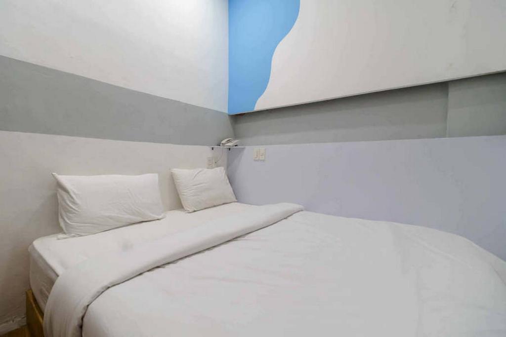 Postel nebo postele na pokoji v ubytování Jotel Guest House Mitra RedDoorz