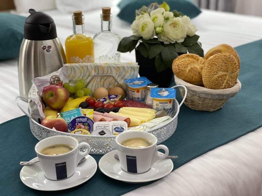 a tray of food and two cups of coffee on a table at Brekner Rooms in Sibiu