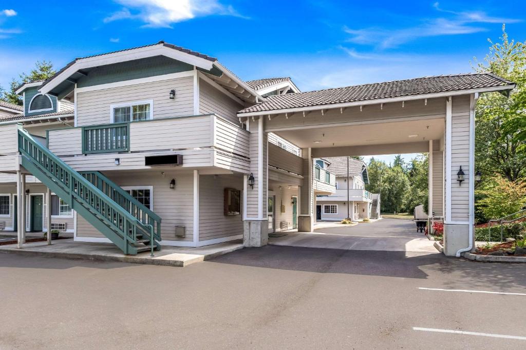 a large white house with a garage at Quality Inn & Suites Bainbridge Island in Winslow