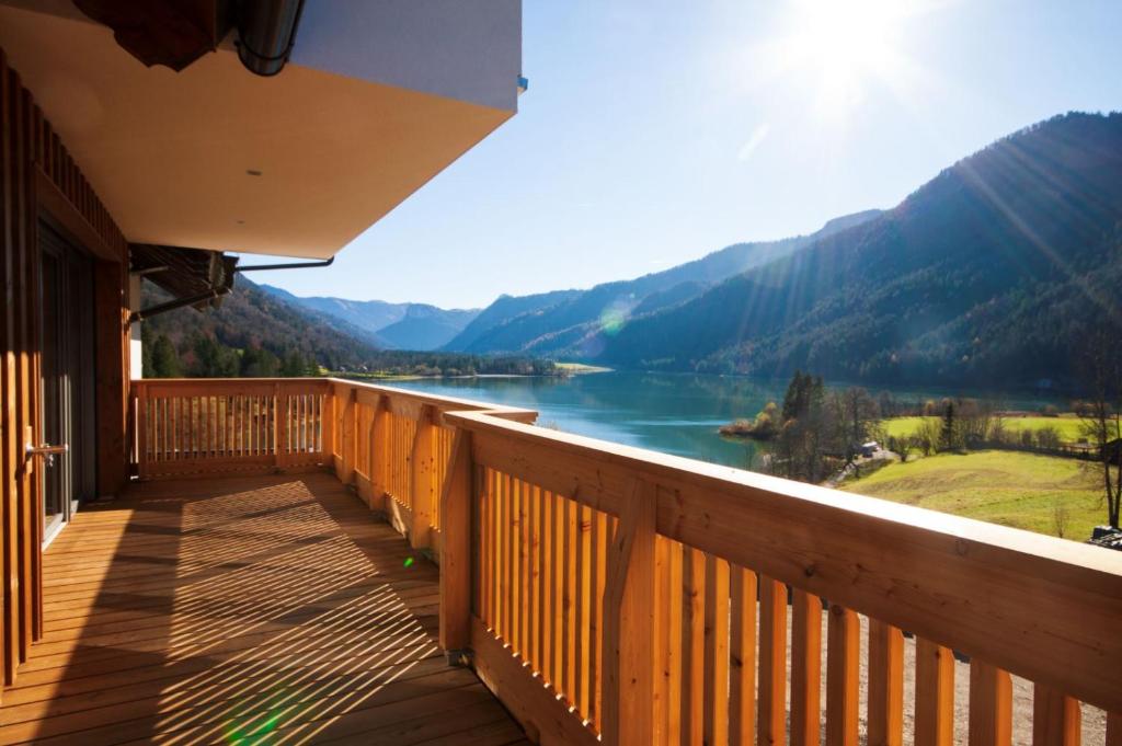 a balcony with a view of a river and mountains at Landhaus Seereith in Faistenau