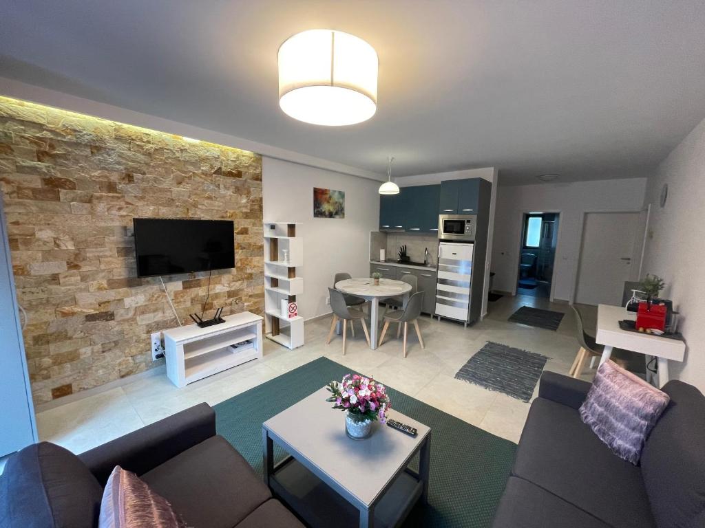 a living room with a couch and a table at Castle Residence apt. Zamorei in Buşteni