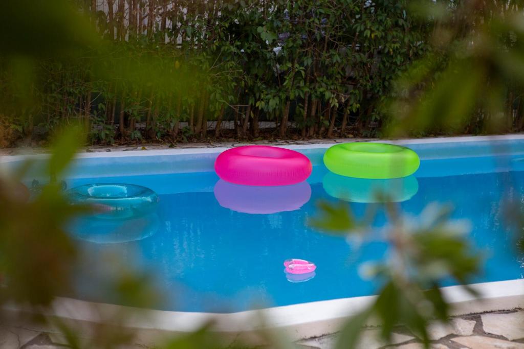 two frisbees floating on a pool of water at VK Villas in Apolpaina