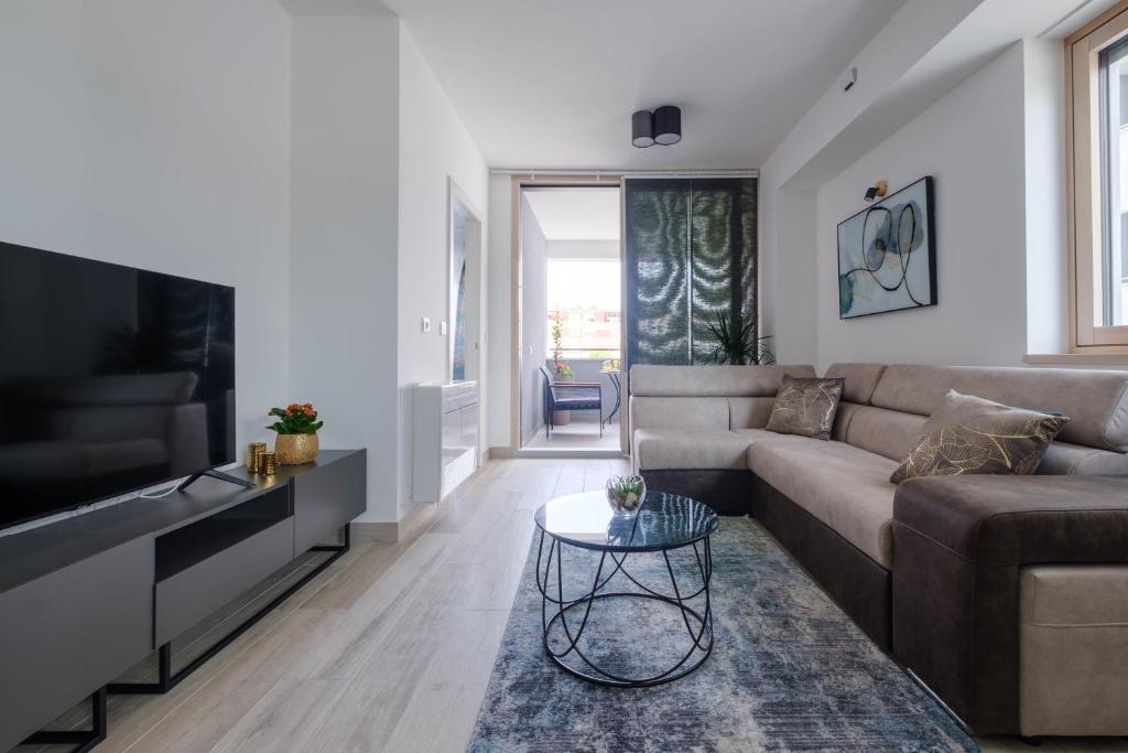 a living room with a couch and a tv at MB Luxury Apartments in Zadar