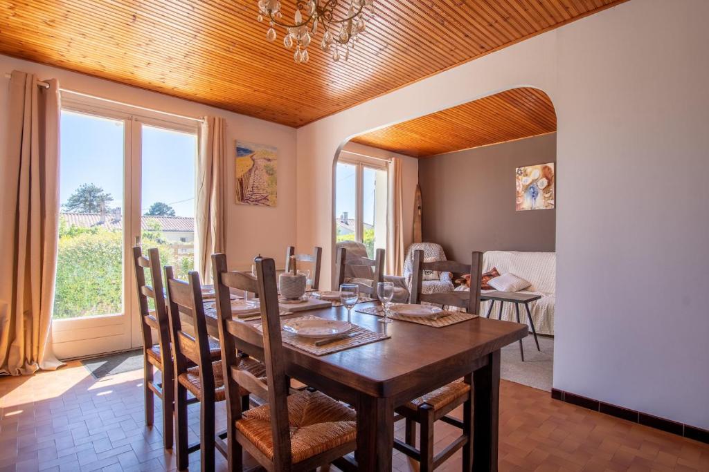 a dining room with a wooden table and chairs at Nature et decouverte a Brem sur Mer in Brem-sur-Mer