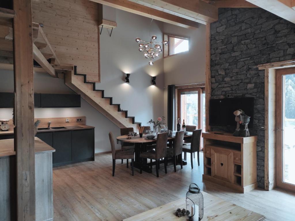 a dining room with a table and a staircase at Chalet Grand Croix - Haut Standing - 8, 10 pers in Lanslebourg-Mont-Cenis