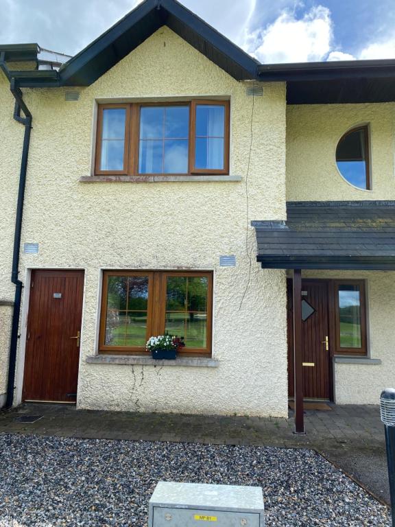 a house with a flower pot in the window at Your very own 19th hole!! in Tipperary