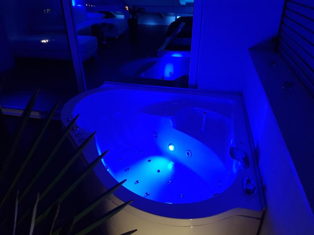 a blue room with a tub with sharks in it at Jacuzzi Penthouse Apartment in Matulji