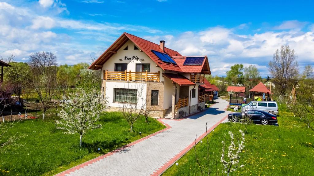 a house with a red roof and a driveway at Casa Nely in Sighetu Marmaţiei