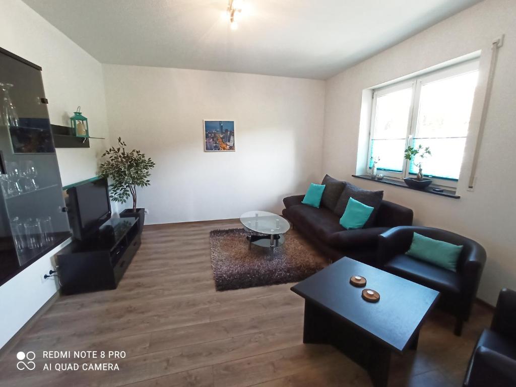 a living room with a couch and a table at Ferienwohnung am Hopfengarten in Illschwang