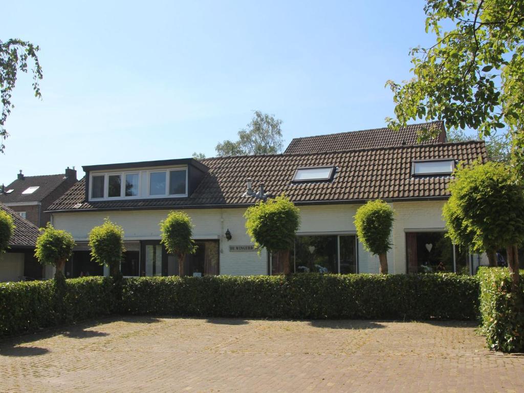 a house with a hedge in front of it at Serene Holiday Home in Ulestraten near Private Forest in Ulestraten