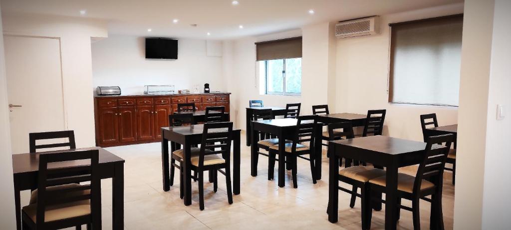 une salle à manger avec des tables et des chaises ainsi qu'une cuisine dans l'établissement Residencial Douro, à Peso da Régua