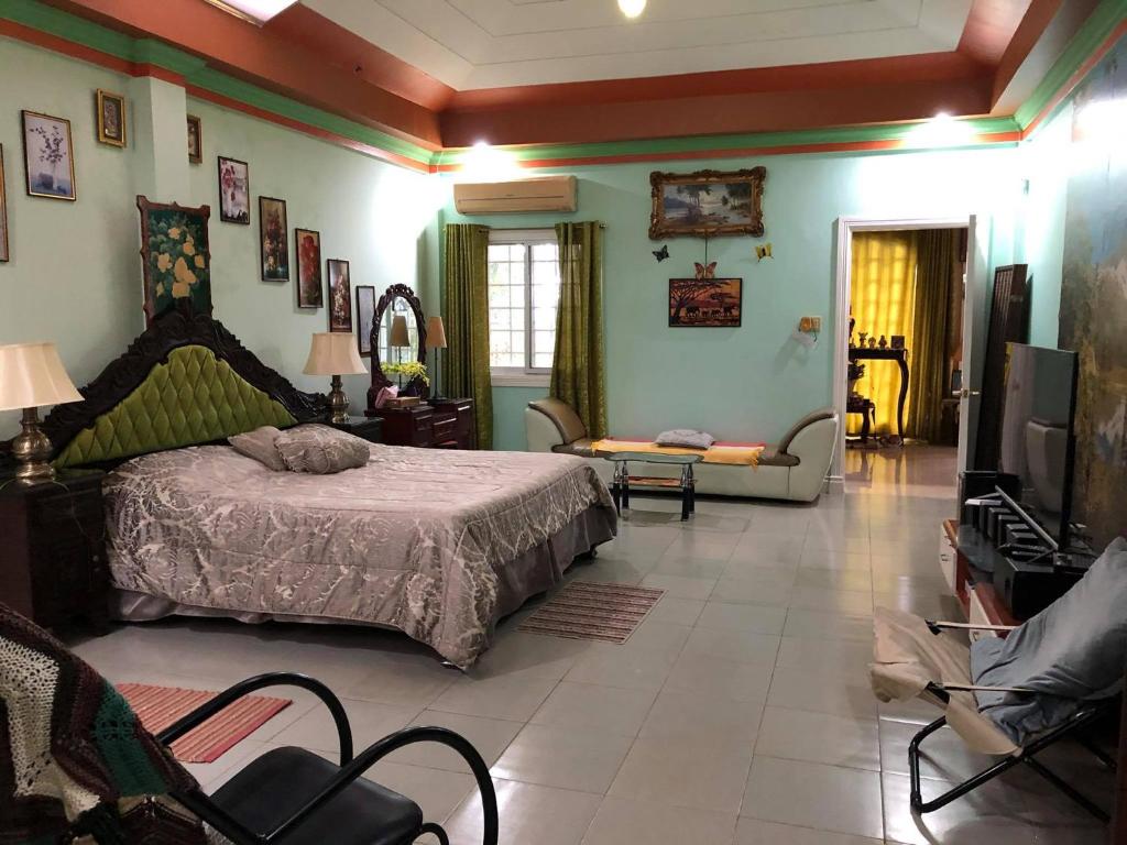 a bedroom with a bed and a tv in a room at Villa 301 B&B in Baclayon