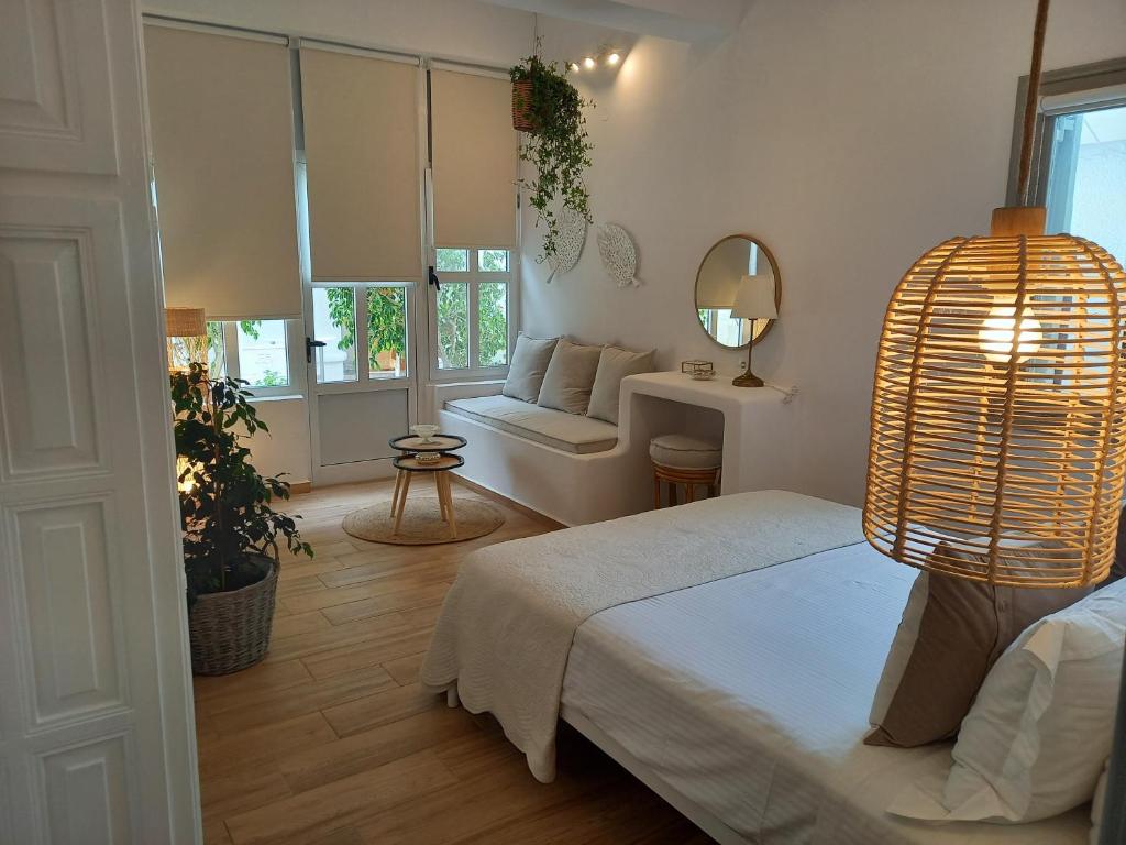 a room with two beds and a couch in it at Patmos Little Suites in Skala