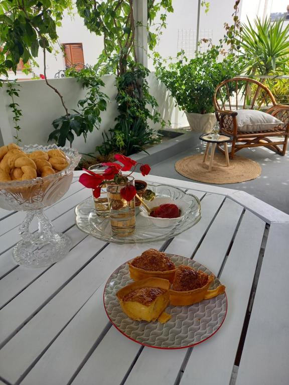 a table with two plates of food on it at Patmos Little Suites in Skala