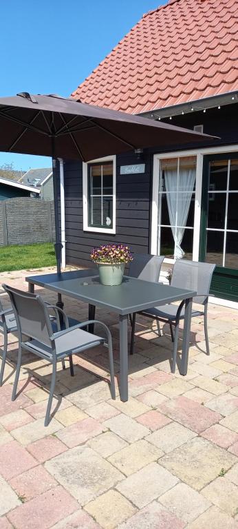 a picnic table and chairs on a patio at Beachloft Zeeland 1 in Scharendijke