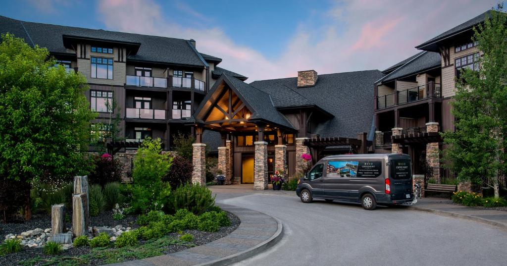 a van parked in front of a large house at Copper Point Resort in Invermere