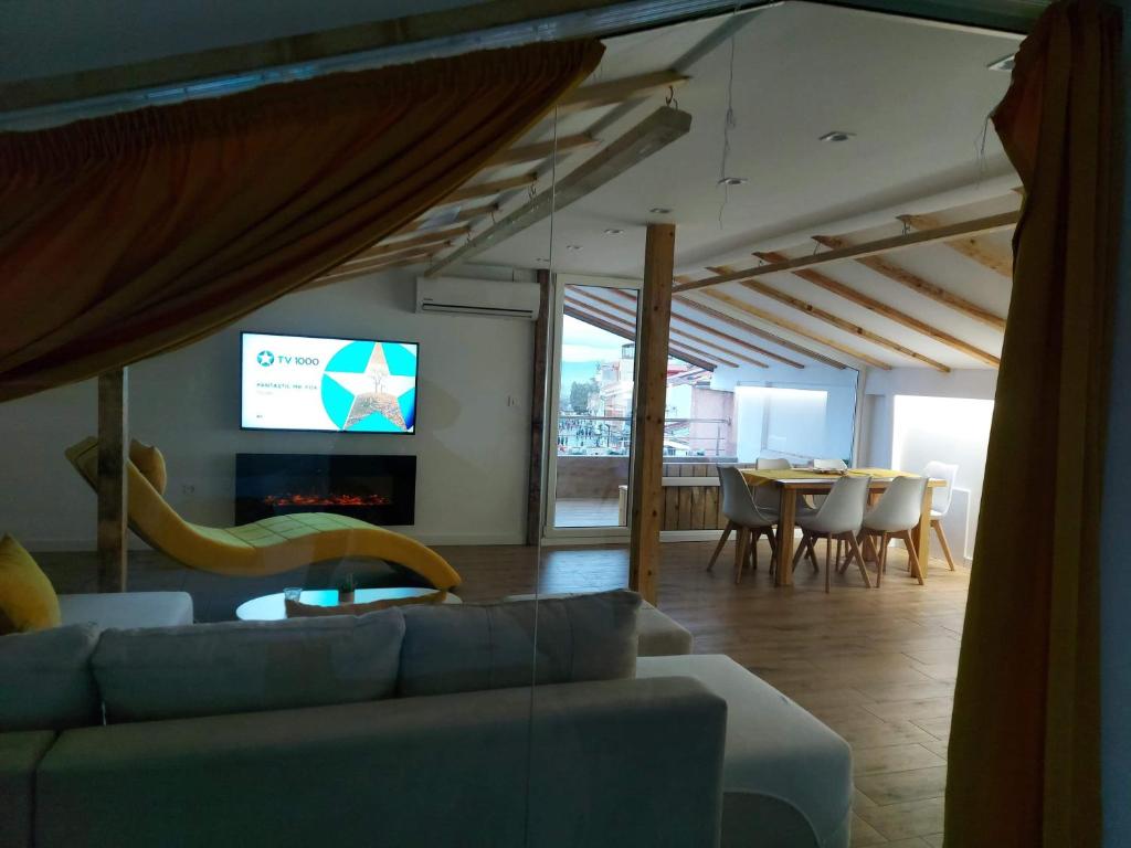 a living room with a couch and a tv and a table at Villa Passage in Ohrid