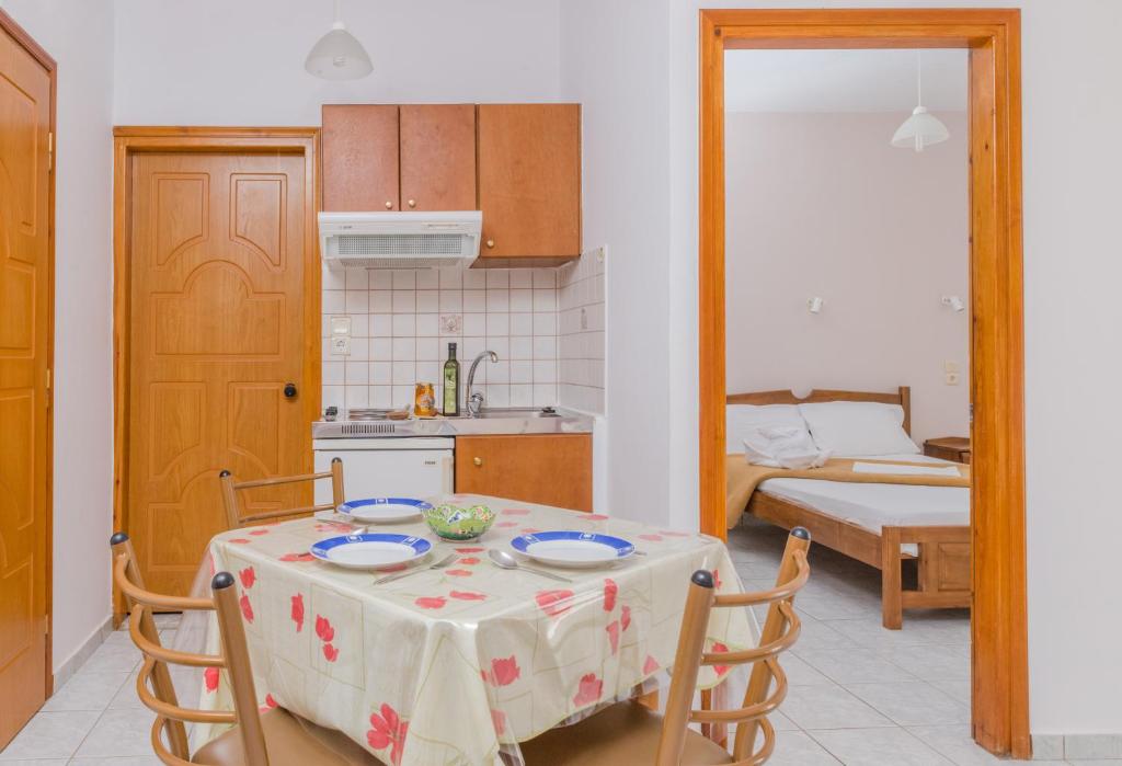 a kitchen and dining room with a table and chairs at Arsinoi Studios and Apartments in Kalamaki