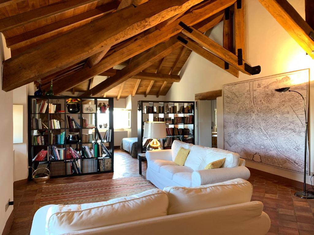 a living room with a couch and a book shelf at Castello di Rocca Grimalda in Rocca Grimalda