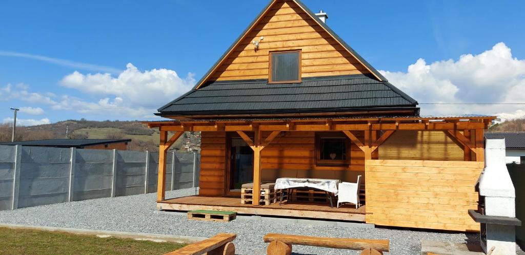 a gazebo with a black roof on a house at Chata BAŠKA na Liptove s vlastným dvorom in Liptovský Mikuláš