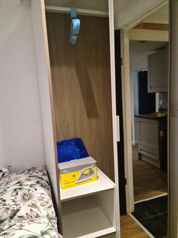 a yellow box on a shelf in a room at Exclusive Private One Bedroom Suite in London