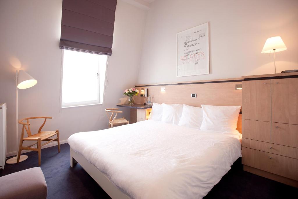 Postel nebo postele na pokoji v ubytování Hotel Van Bunnen