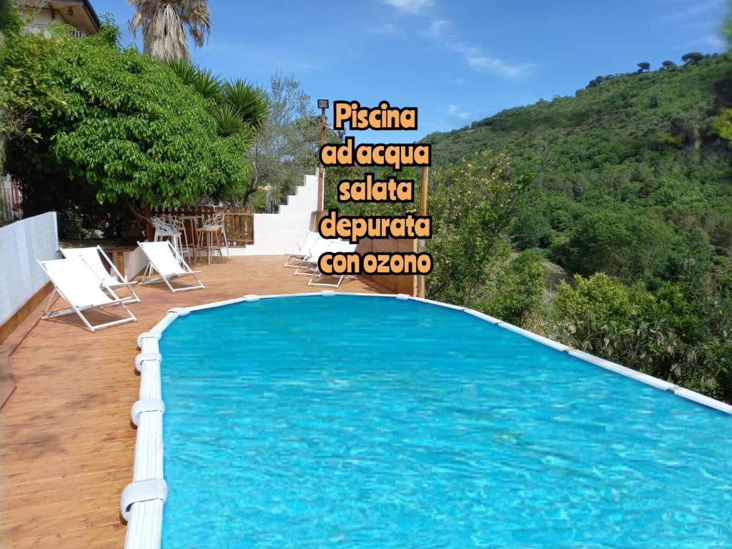 a swimming pool with a sign on the side of the pool at Agriturismo Trinacria Pool&Rooms in Piazza Armerina