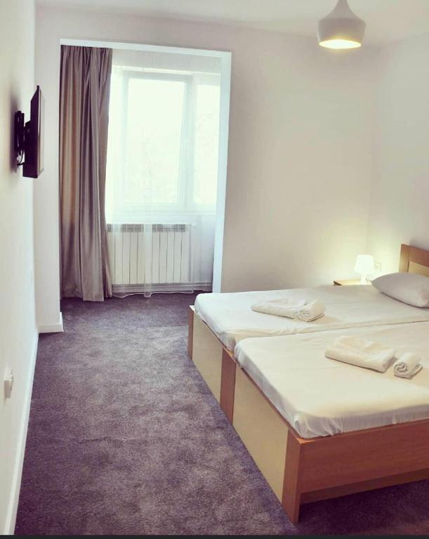 Postel nebo postele na pokoji v ubytování MANEA Orsova