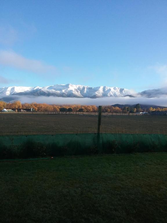 a view of snow covered mountains in a field at Best view on Westview in Hanmer Springs