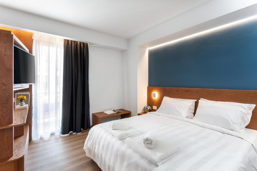 Postel nebo postele na pokoji v ubytování DAYS City Suites