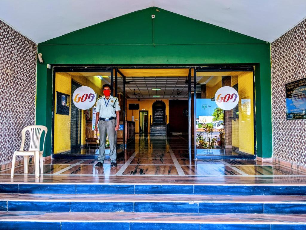 a man standing in the doorway of a store at Mapusa Residency in Mapusa