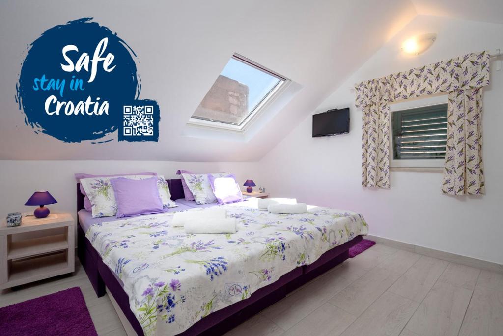 a bedroom with a bed and a sign on the wall at Apt Bobotovi in center of Stari Grad, Hvar in Stari Grad