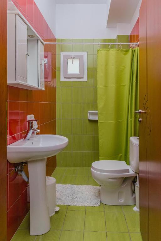 a bathroom with a sink and a toilet at Arsinoi Studios and Apartments in Kalamaki
