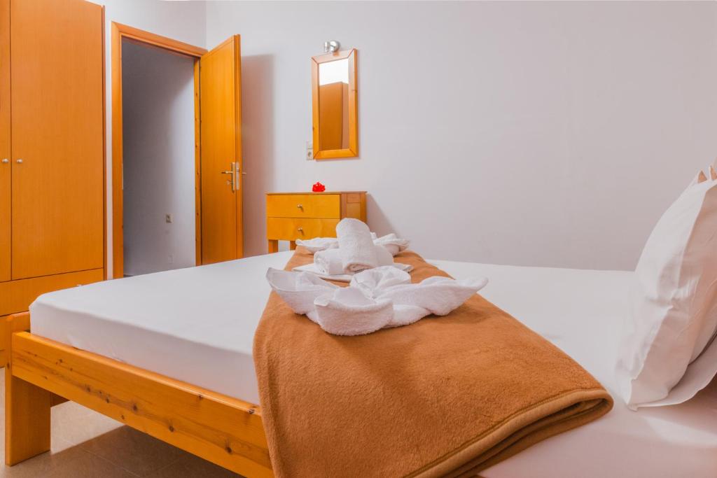 a bedroom with a bed with a towel on it at Arsinoi Studios and Apartments in Kalamaki