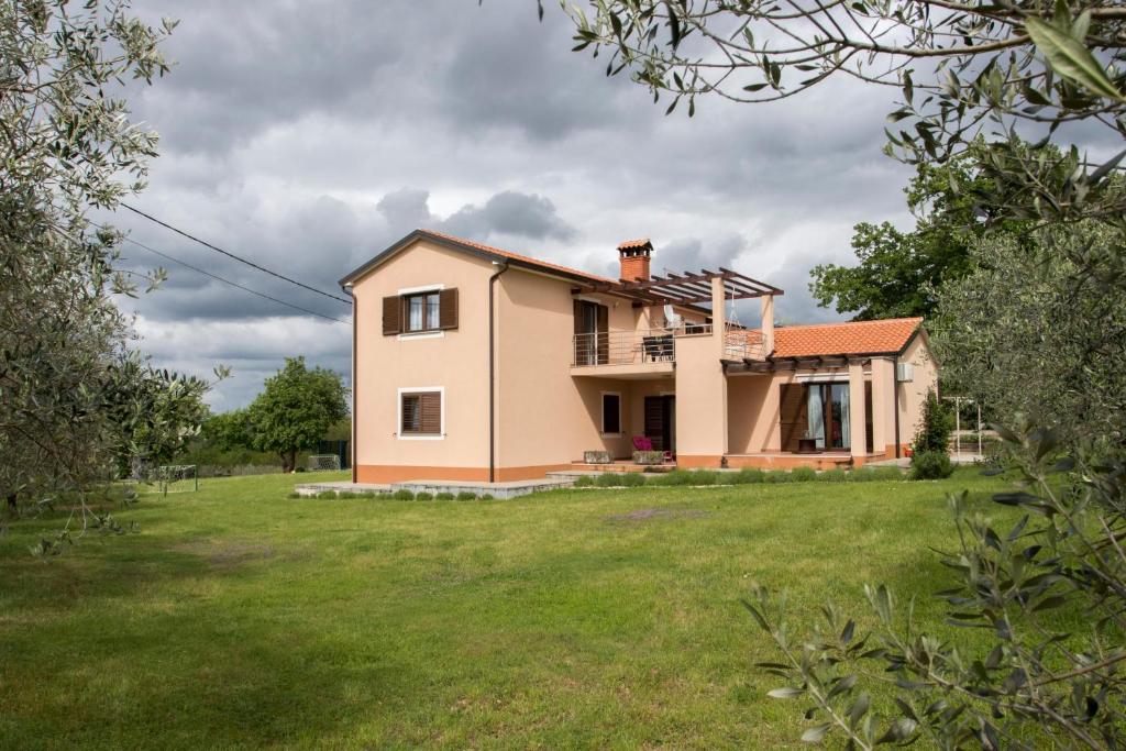 a house with a large yard in front of it at Apartment Mara in Vižinada
