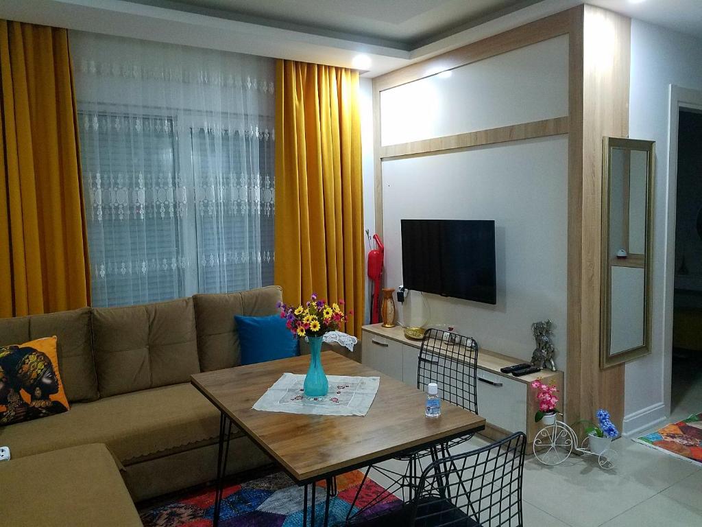 a living room with a couch and a table at GUL APART ANTALYA in Aksu