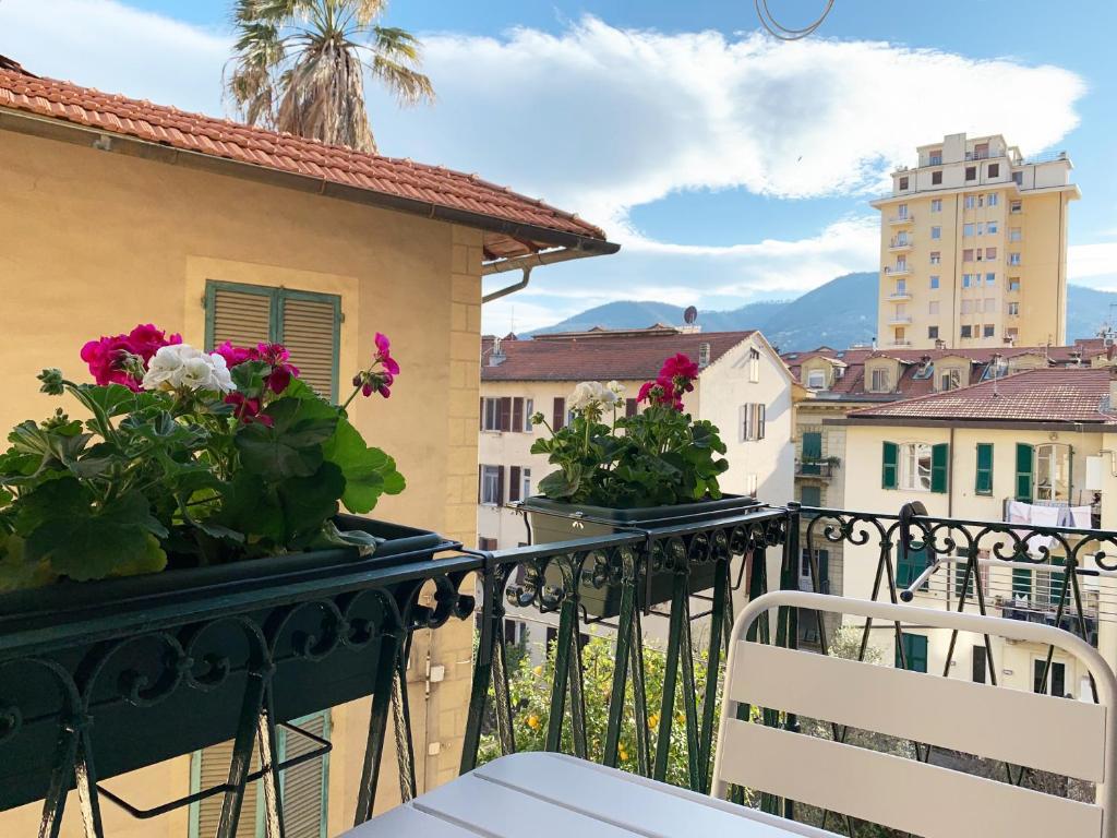 a balcony with flowers and a view of a city at Cielo&Mare affittacamere in La Spezia