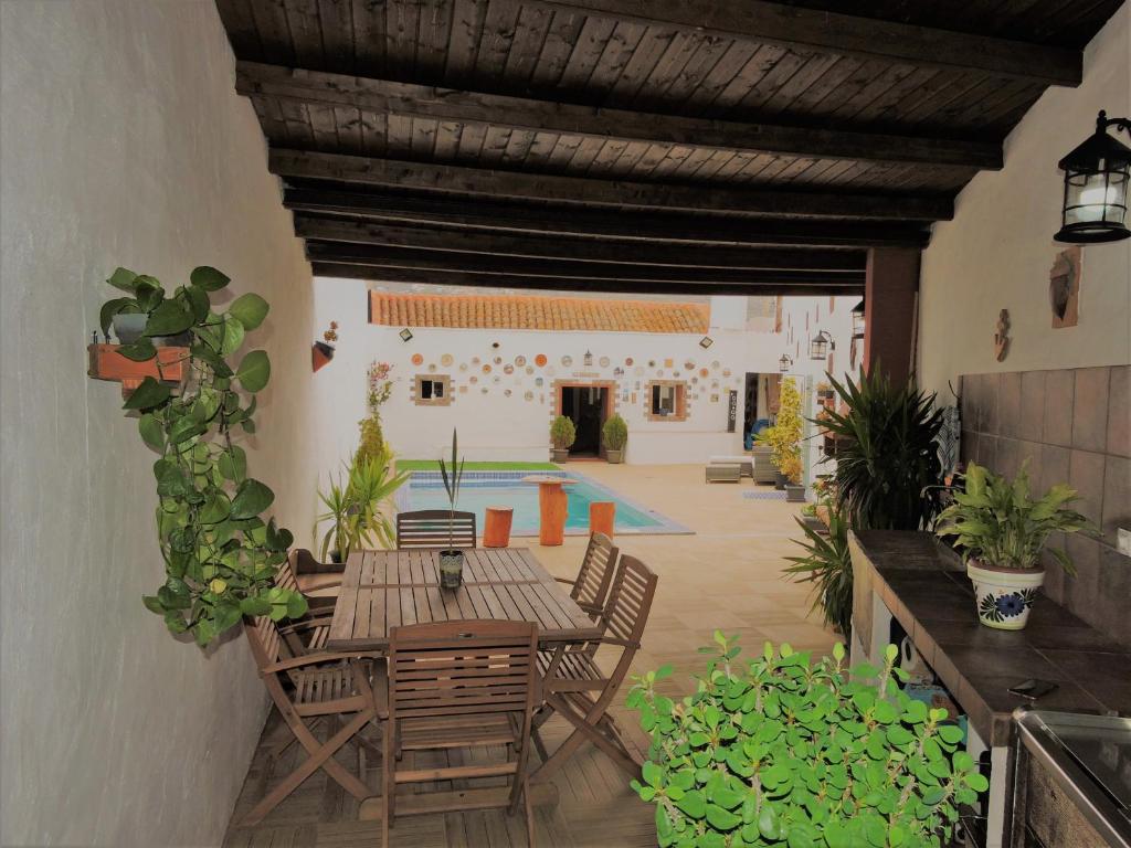 une terrasse avec une table, des chaises et une piscine dans l'établissement La Bellotita-Gáldar, à Gáldar