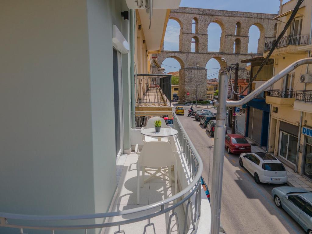 a balcony of a building with a table and a street at Tompazi 2 in Kavala