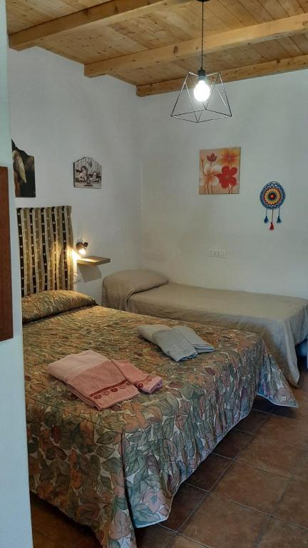 a bedroom with two beds in a room at Casa Vacanza e Camera Fabiola in Castellammare del Golfo