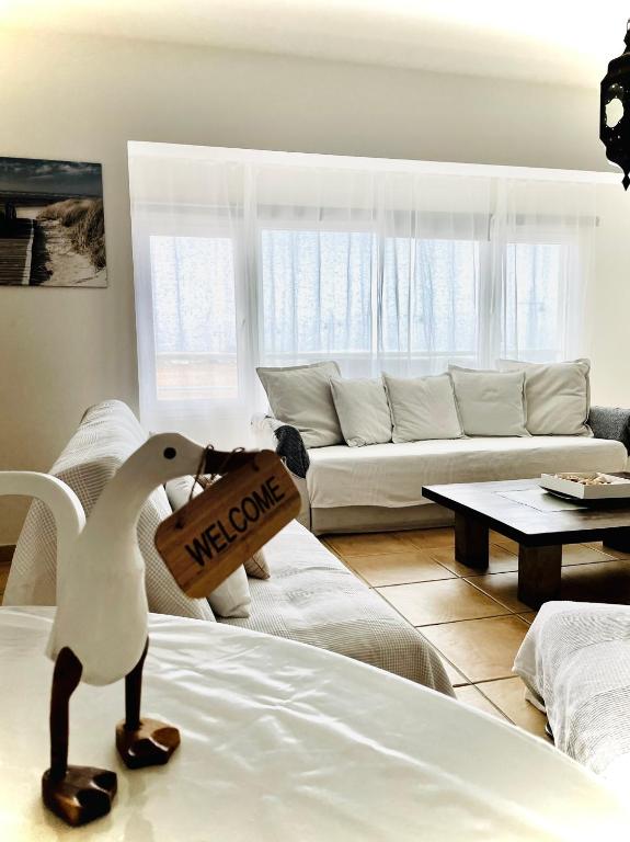 a toy chicken sitting on a bed in a living room at MY OCEAN HOME - Breathtaking location, Steps to the ocean, Spacious sea view, Fully Equipped and Well-Furnished with Private Entrance and High-Speed Fiber Optic Internet in Corralejo