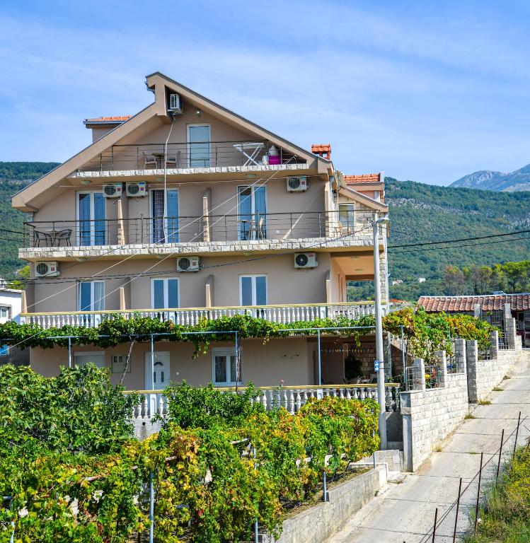 a house on a hill with vines at Apartments Ivana in Tivat