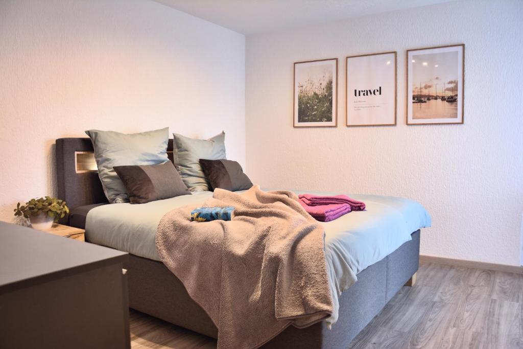 a bedroom with a bed with a blanket on it at Auszeit vom Alltag- schöne, moderne Wohnung am See in Immenstaad am Bodensee