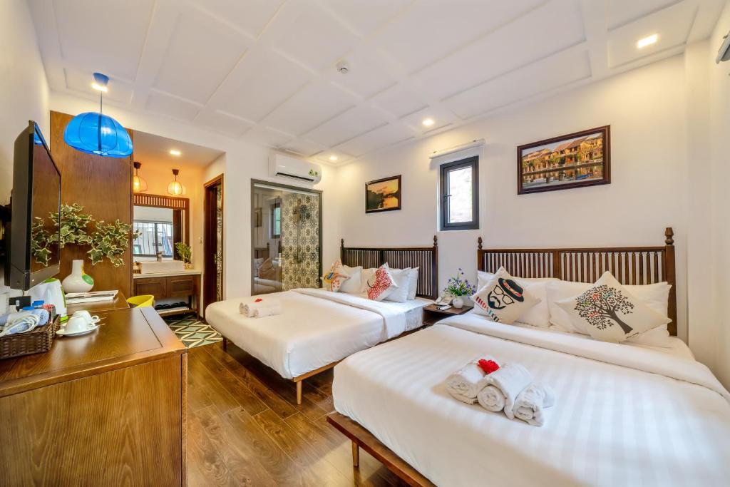 Postel nebo postele na pokoji v ubytování Son Trang Hotel Hoi An